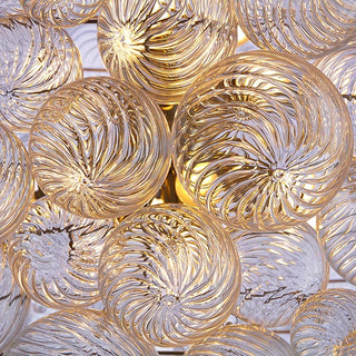 detail view of lumious hand-blown spiral glass orbs wih ripple pattern in art deco modern design