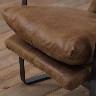 close-up detail of whiskey leather seat and matte black steel frame 