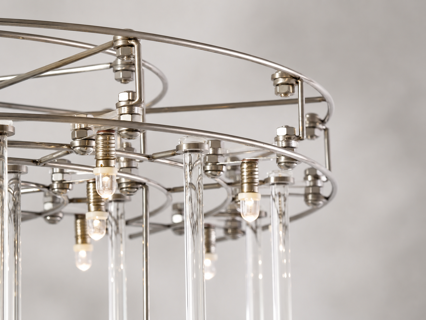 Close-up of the Aura rectangular chandelier’s polished chrome frame, suspended LED lights, and clear glass rods.