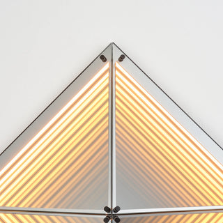 Close-up of the Axis LED Infinity Glass Mirror showing layered warm LED lines and precision-cut mirrored edges.