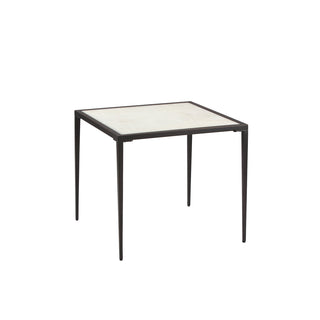 angle view of modern white calcite side table with slim metal legs