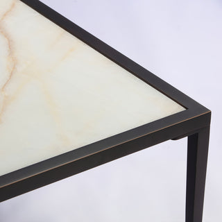 detail view of side table showing natural calcite pattern and black corner frame