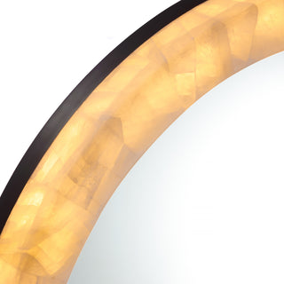 close up detail of calista small round LED mirror frame with golden natural stone
