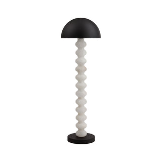 Calista sculptural modern floor lamp on white background, stacked stone column and black dome shade, light off