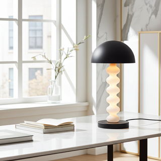 Close up of Calista sculptural table lamp in bright interior, stacked sphere base and matte black shade