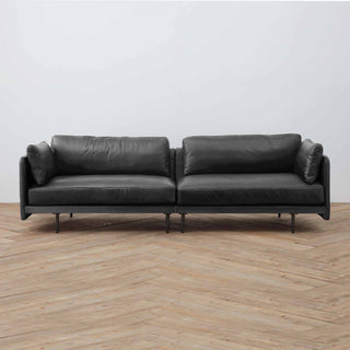 Edge Collection four-seater sofa in new black leather, wood floor background