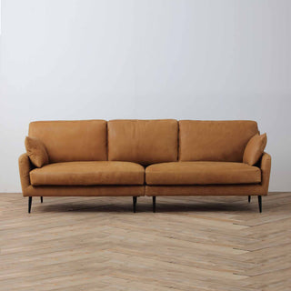 front view of Essence Collection couch sofa in cognac brown leather, wood floor background, single-seat view