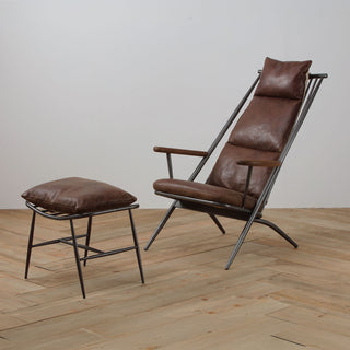 angled view of light brown leather lounge chair and ottoman with metal frame and wood armrests on wood floor
