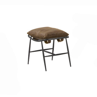angled view of whiskey leather footstool with metal frame legs