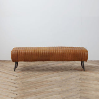 front view  with wood floor background of 60-inch cognac bench with slim metal legs