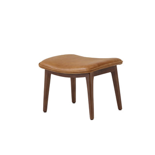 angle view of modern cognac leather lounge footstool with solid wood legs