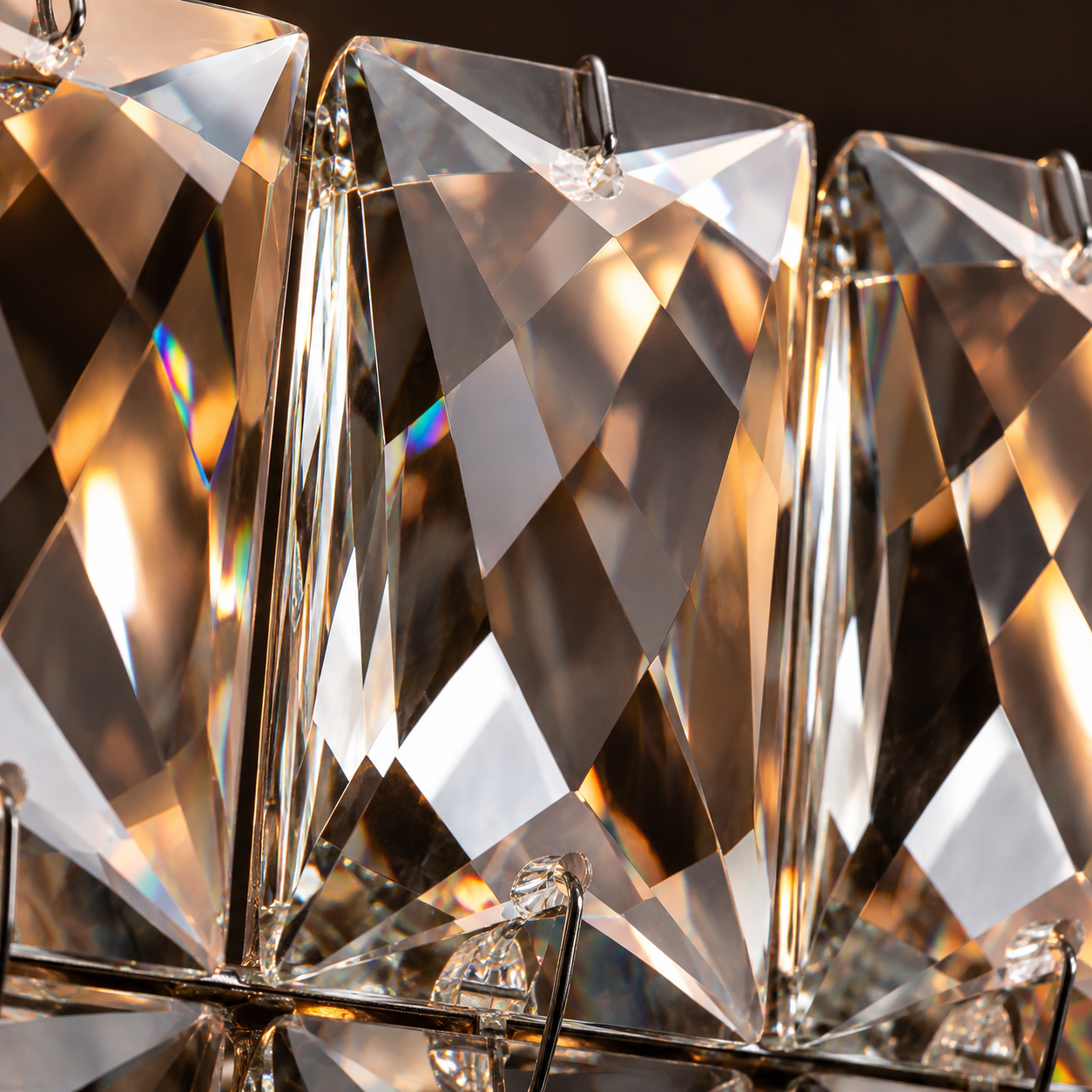 Close-up of faceted K9 crystals on the Lattice lighting collection, showing precise cuts and warm light reflections.