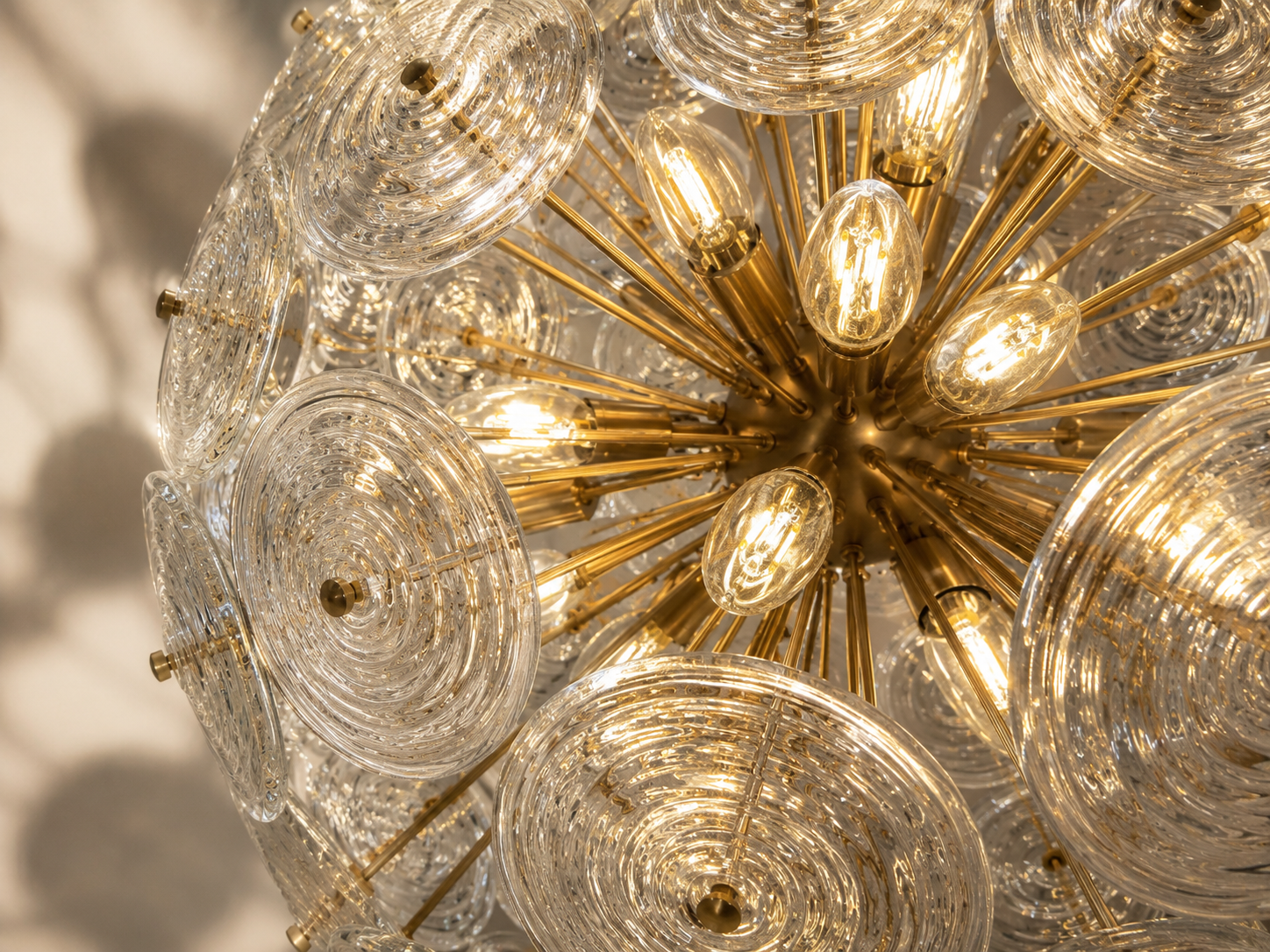 Close-up of illuminated bulbs surrounded by the Lattice chandelier’s faceted crystal blocks