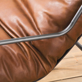 close-up view of soft light brown leather texture with subtle wrinkles and black metal frame detail
