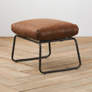 angle view with background of modern light brown leather footstool with metal frame