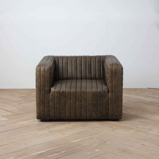 front view of 1-seater ribbed leather armchair in warm whiskey brown color, light wood flooring