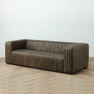 angled view of 3-seater ribbed leather sofa in whiskey brown color and finish
