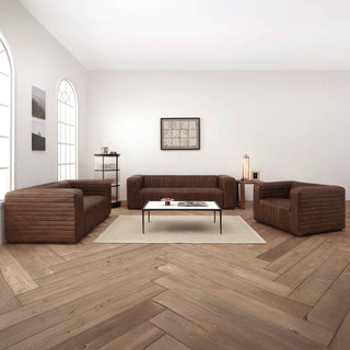 Metro Stripe leather sofa styled in modern living room setting with wall art and rug