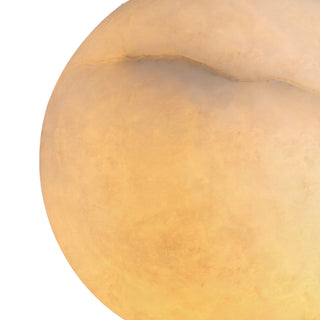 Close-up of natural selenite crystal sphere, showing organic marbling and soft amber glow of the Moonlit pendant light
