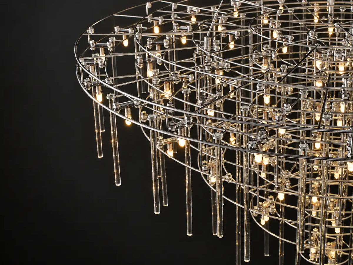 Aura Round Tiered Glass Rod Chandelier: slim steel rings in open tiers, clear glass rods each lit by a warm LED — airy, modern sculptural lighting