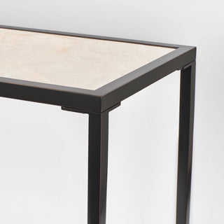 Opposite corner detail showing the calcite tabletop fitted within the rectangular black frame and leg.