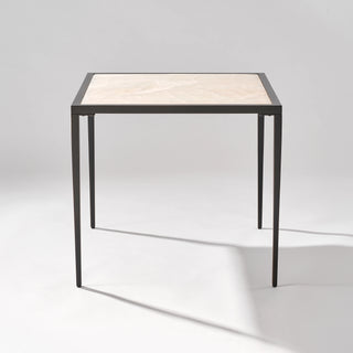 Front view of the Calcite Natural Stone Side Table with a pale veined top and slim black frame.