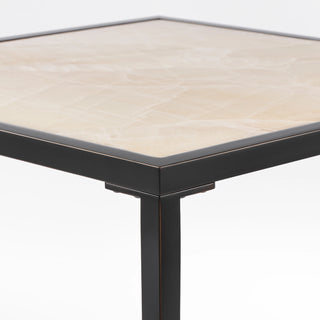 Opposite corner detail showing the calcite top fitted within the black perimeter frame.