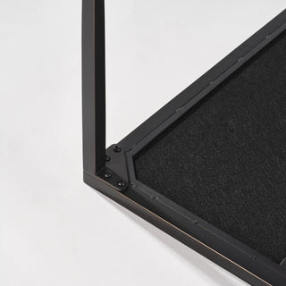 Underside corner detail showing the black support panel, frame fasteners, and leg attachment.
