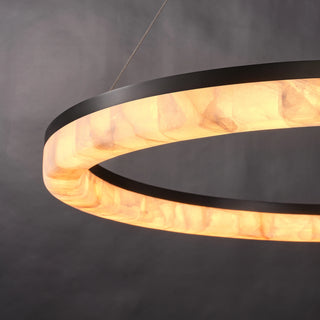 Close-up of the illuminated Calista Ring Calcite Stone Chandelier showing warm light through natural calcite panels.