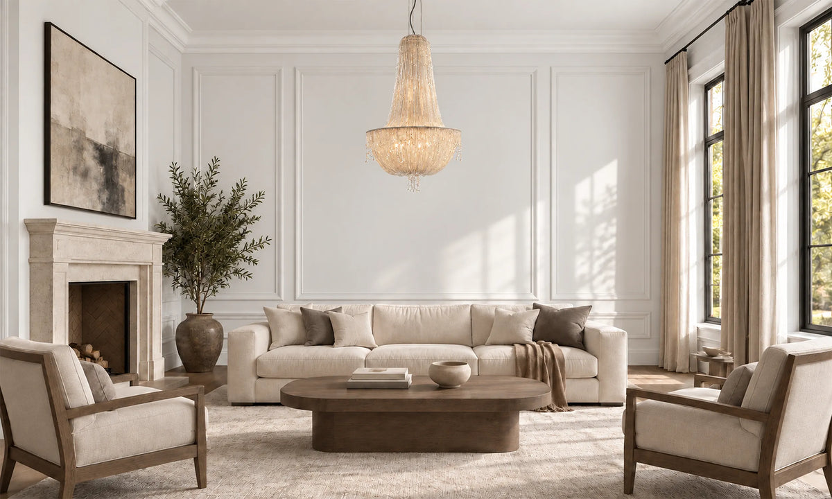 Transitional living room lighting: the Cascade Empire Glass Bead Chandelier glows over a cream sofa by a stone fireplace. Empire beaded chandelier
