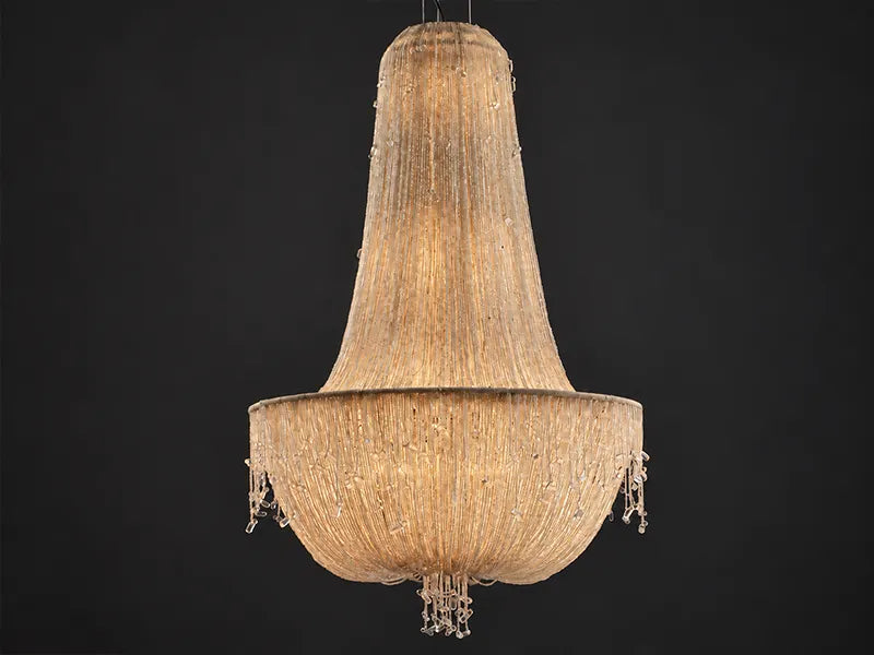 Cascade Empire Glass Bead Chandelier, lit: a tall Empire silhouette draped in ivory glass bead strands, with a beaded fringe. Empire style chandelier