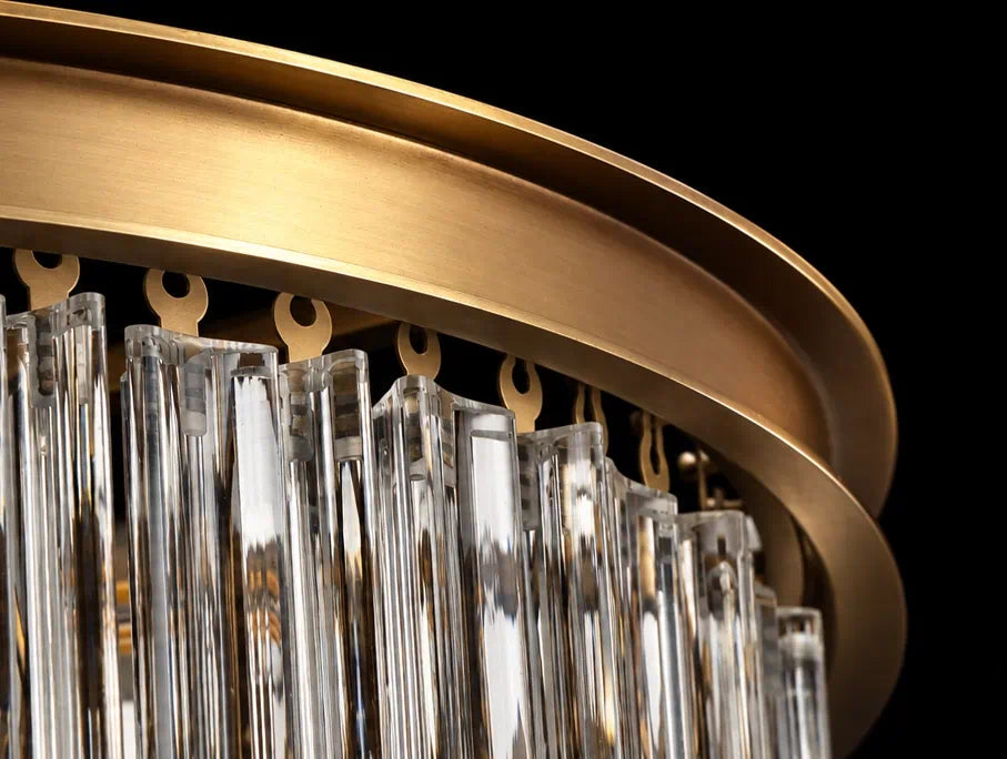 Individually suspended glass rods beneath the antique brass frame of the Marais Glass Chandelier.