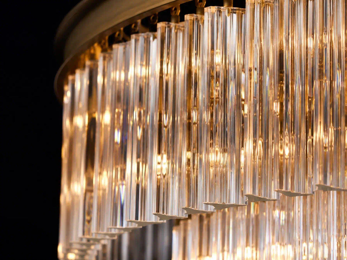 Illuminated glass rods on the Marais Glass Chandelier creating layered warm reflections.