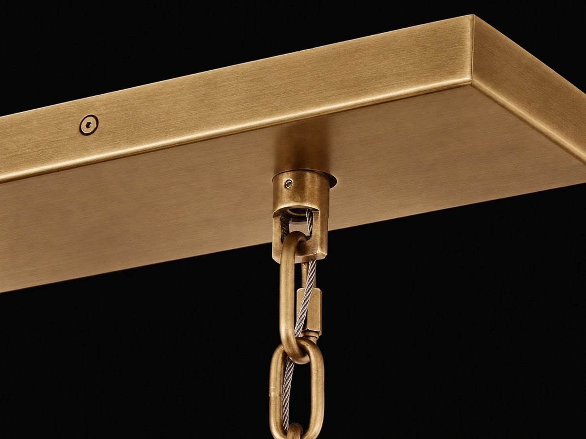 Antique brass canopy, chain suspension, and silver safety cable of the Marais Glass Chandelier.