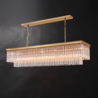 Three-quarter view of the illuminated Marais 60-inch rectangular glass chandelier on a black background, highlighting warm light through layered clear glass rods and its brass-finished frame.
