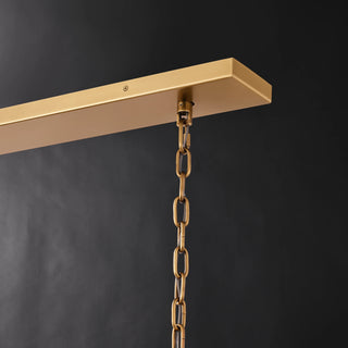 Close-up of the brass-finished linear canopy and chain suspension on the Marais 60-inch rectangular glass chandelier.