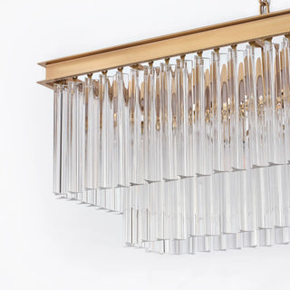 Unlit side detail of the Marais 60-inch rectangular glass chandelier on a white background, highlighting the clear glass rods and brass-finished upper frame.