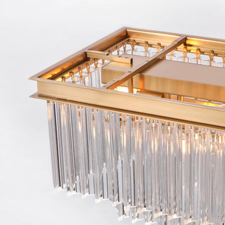 Top construction detail of the illuminated Marais 60-inch rectangular glass chandelier, showing its brass-finished inner frame and suspended clear glass rods.