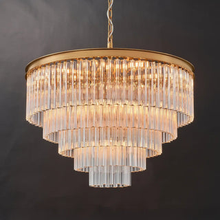 Marais five-tier glass rod chandelier with a round frame in Aged Brass finish, glowing with warm light.