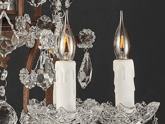 Rustline crystal chandelier cycling through off, medium, and high brightness, with warm light reflecting through faceted crystal pendants.