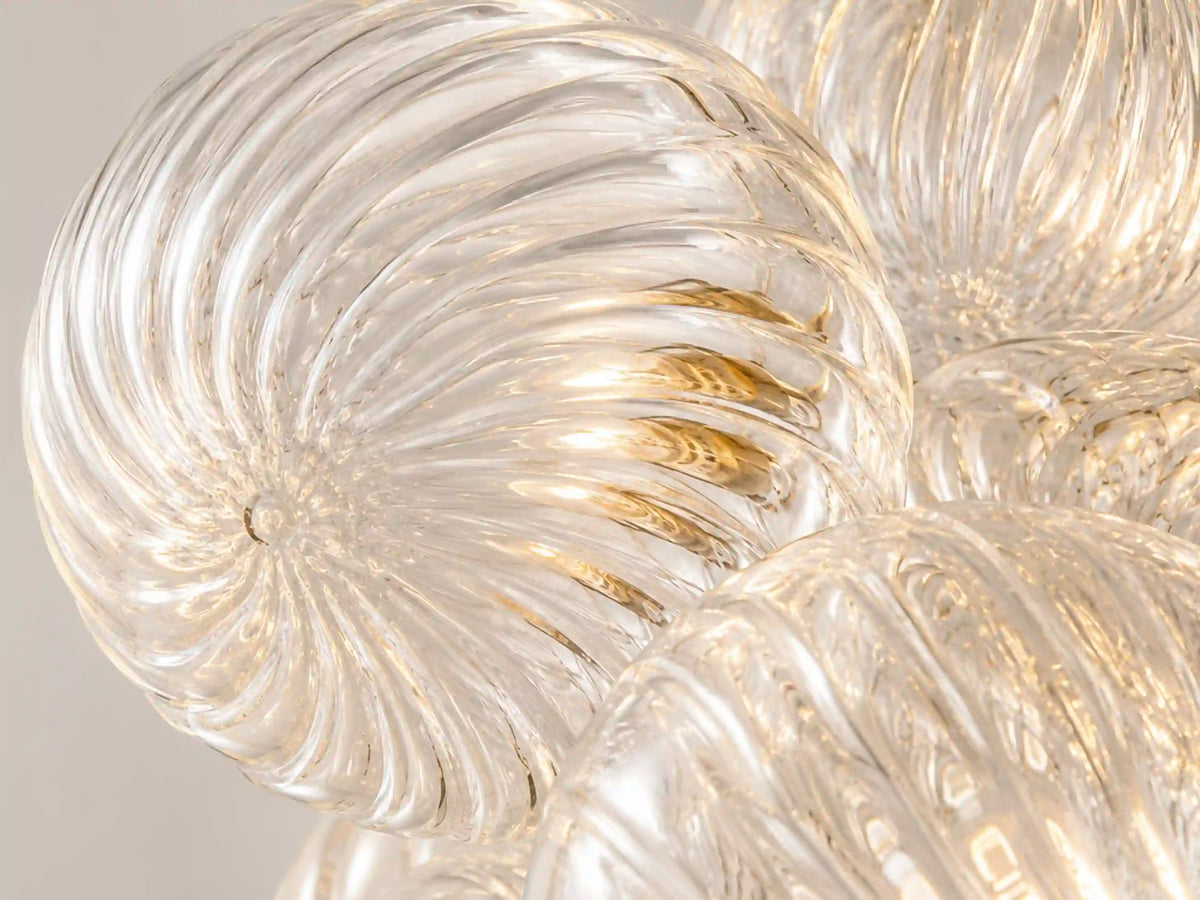 Macro of the Spiral Bubble chandelier's clear spiral-ribbed glass globes, showing the swirl texture where the bubbles overlap