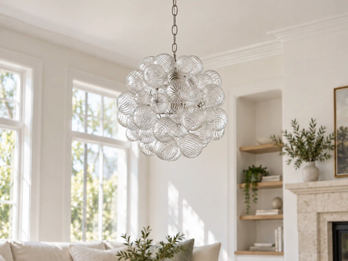 Spiral Bubble Mouth-Blown Glass Chandelier hanging from a chain in a bright living room with a stone fireplace