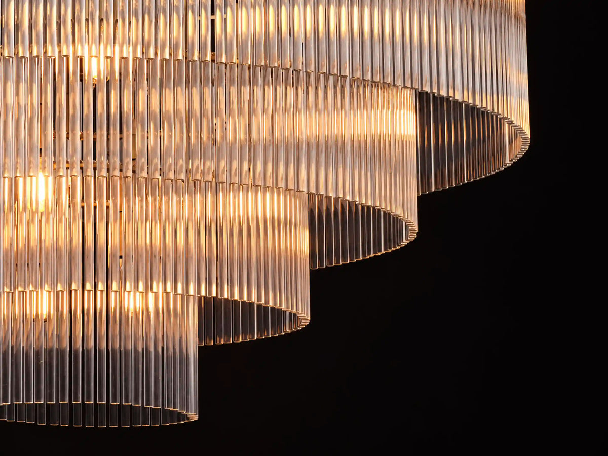 Illuminated tiers of clear glass rods form the stepped silhouette of the Timelore chandelier.
