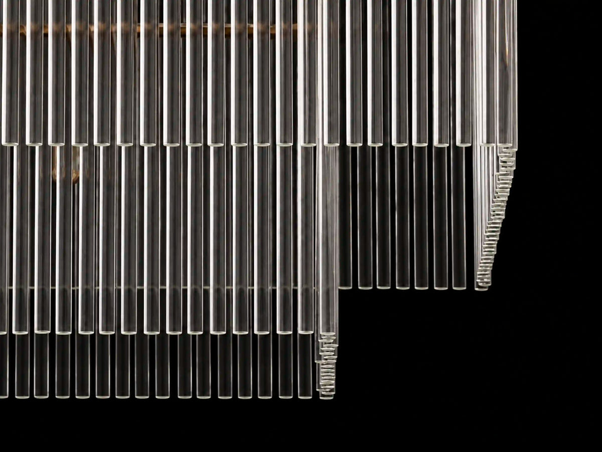 Unlit Timelore chandelier showing layered clear glass rods against a black background.