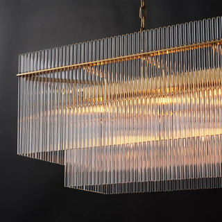 Lit corner of the Timelore chandelier, clear glass rods passing through the frame edge, rising above it and hanging below