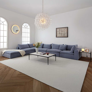 Moorizon Balance Collection blue fabric sofas, spiral bubble chandelier, calista wall mirror, stone spectrum coffee table, moonlit table lamp with contemporary sectional sofa design