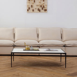 Calcite Spectrum coffee table with natural stone top and blackened brass frame and Harmony Hug electric reclining fabric sofa, Moorizon