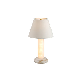 Calista table lamp on white background with LED stone light on, warm golden glow along the stone column