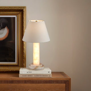 Moorizon Calista stone table lamp on a nightstand, warm glow in a modern bedroom