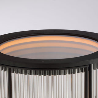 top-down detail view of round LED bar cabinet with brass metal top and fluted glass